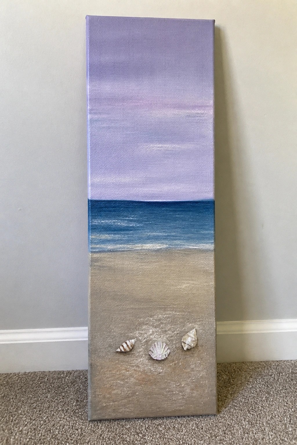 Vertical painting of purple sky over blue ocean and sandy beach with seashells.