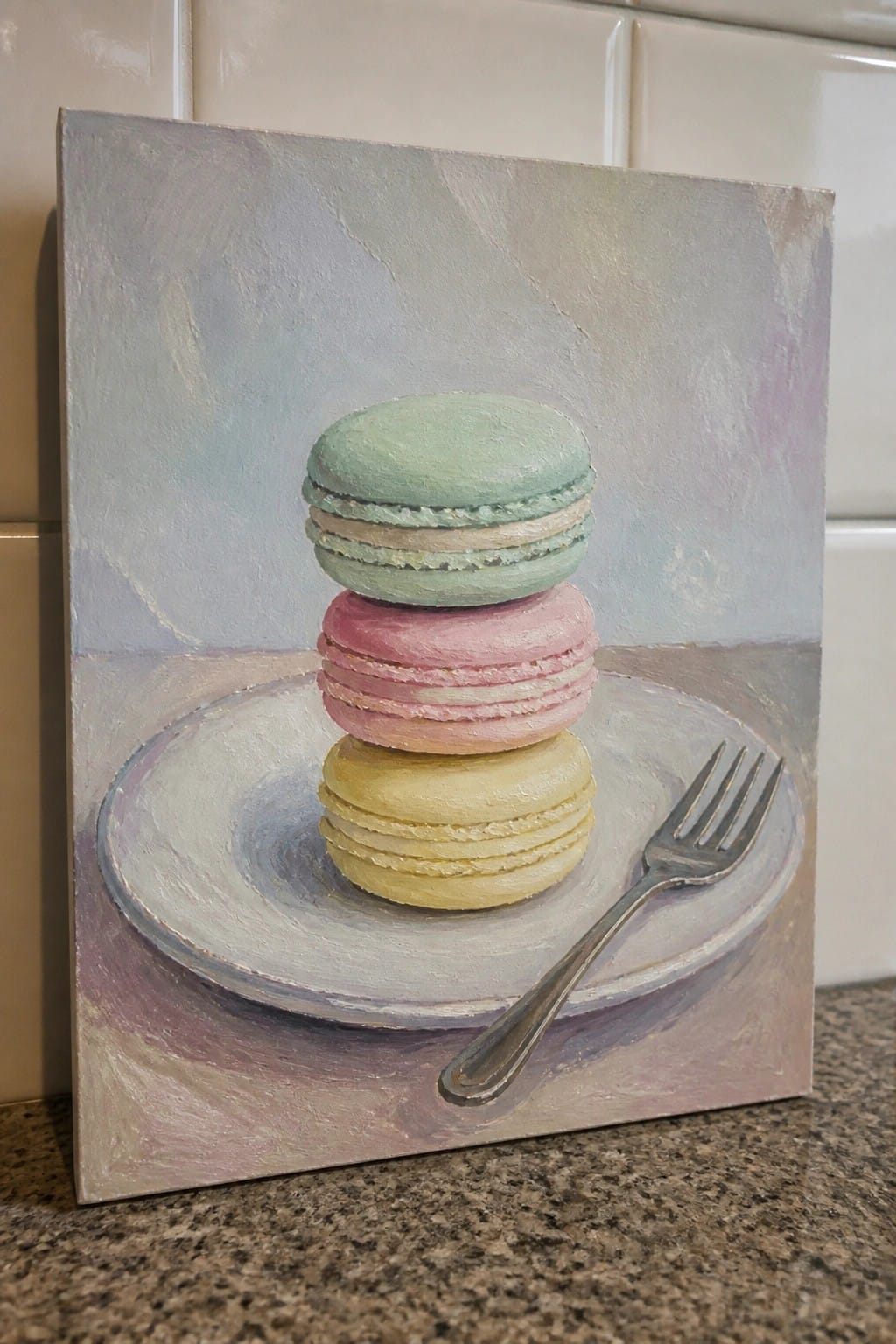 Pastel painting of stacked green, pink, and yellow macarons on a plate with fork