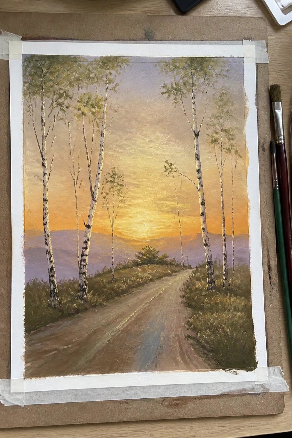 A realistic oil painting of a dirt road curving through fields lined with white birch trees under a glowing orange sunset with purple hills in the distance.