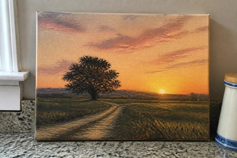 23 Glowing Sunset Landscape Oil Paintings That Capture Golden Evening Skies Oil painting of winding dirt road curving to lone tree under orange sunset skies