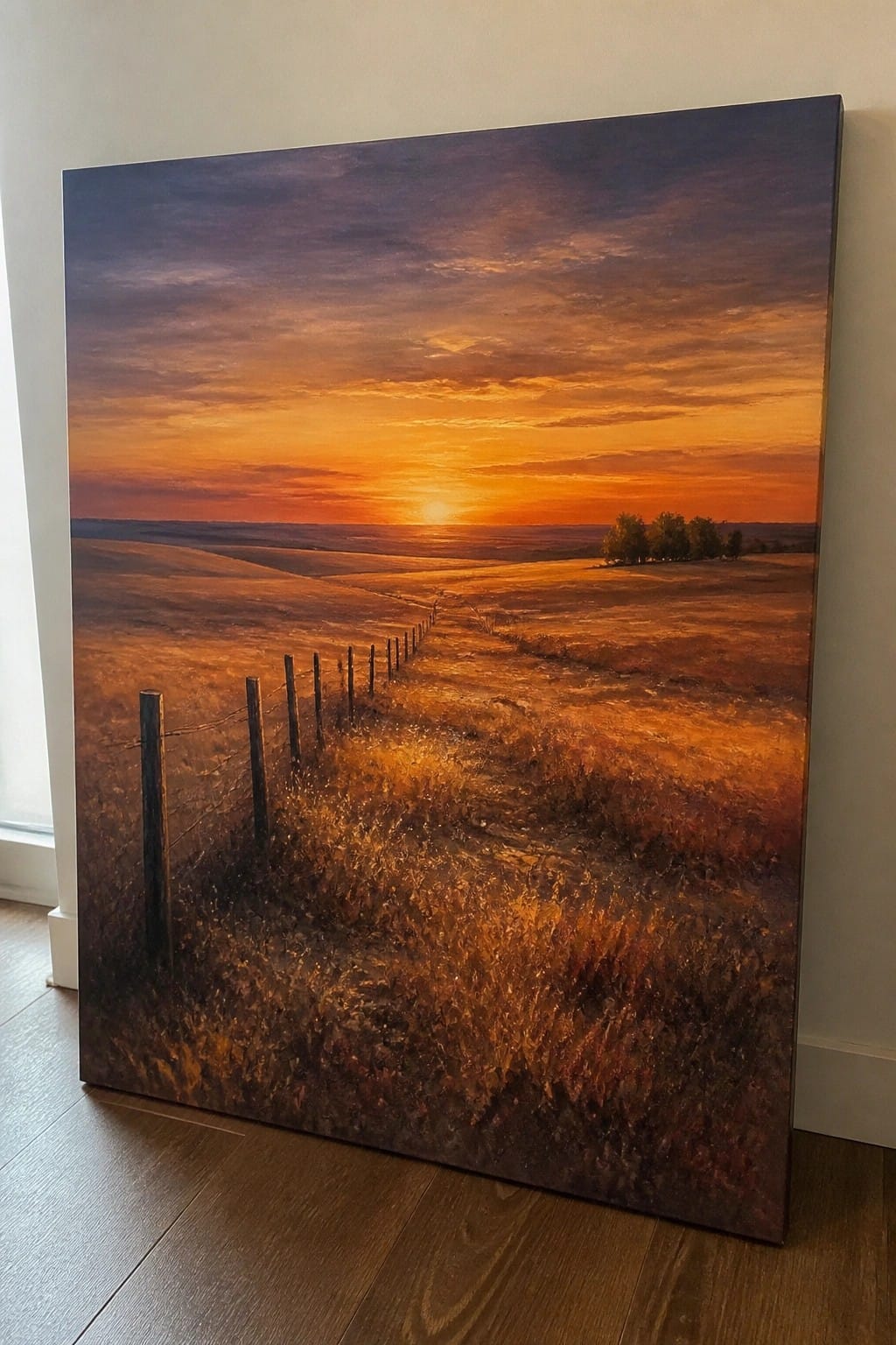 Vibrant sunset painting over golden fields with wooden fence and rolling hills.