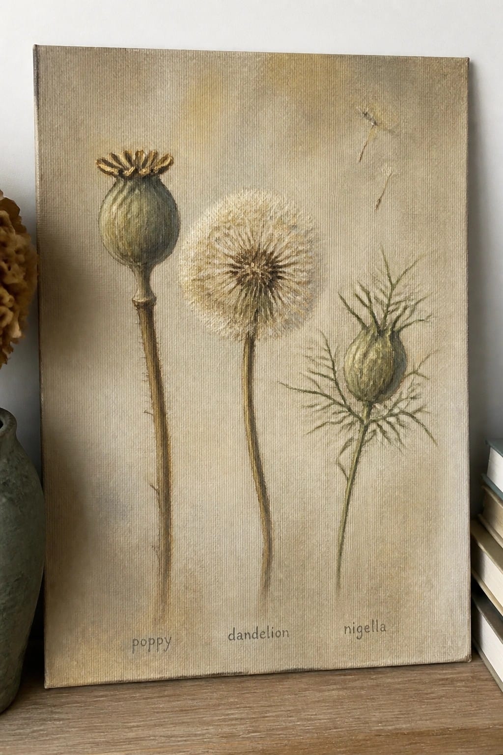 Botanical canvas painting of labeled poppy, dandelion, and nigella seed heads in neutral tones
