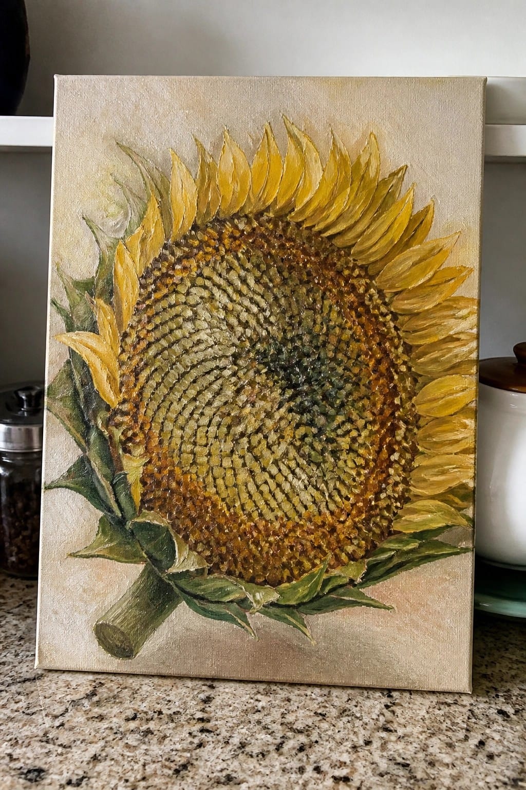 Textured sunflower painting with yellow petals on beige canvas atop kitchen counter