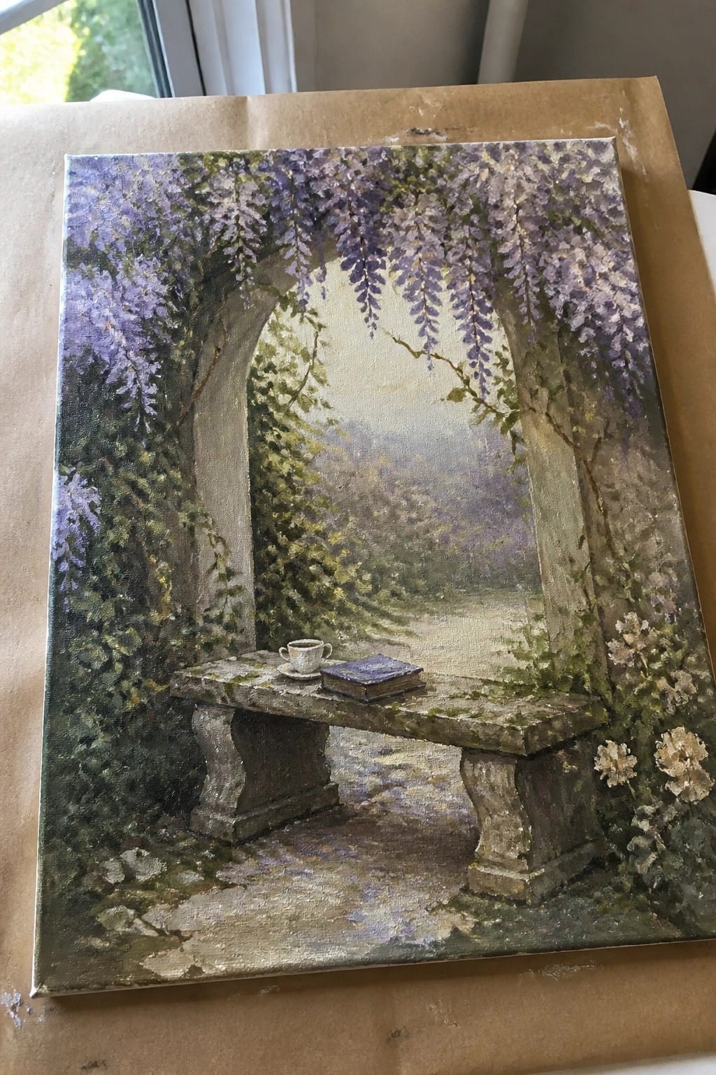 Painting of stone bench under purple wisteria arch with teacup and book on canvas