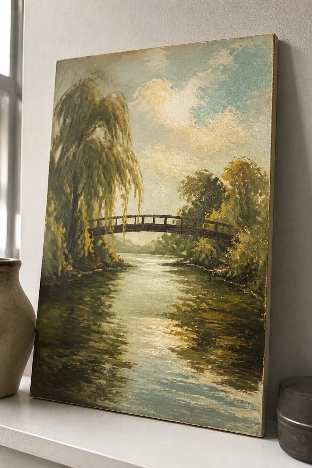 Landscape painting of river with arched bridge and weeping willow tree on wall