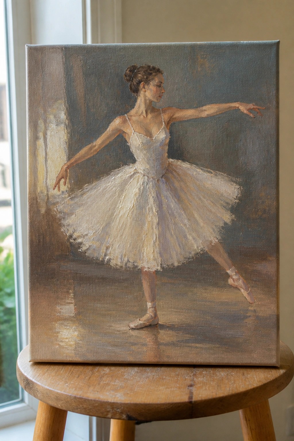 Oil painting of ballerina in white tutu on canvas atop wooden stool