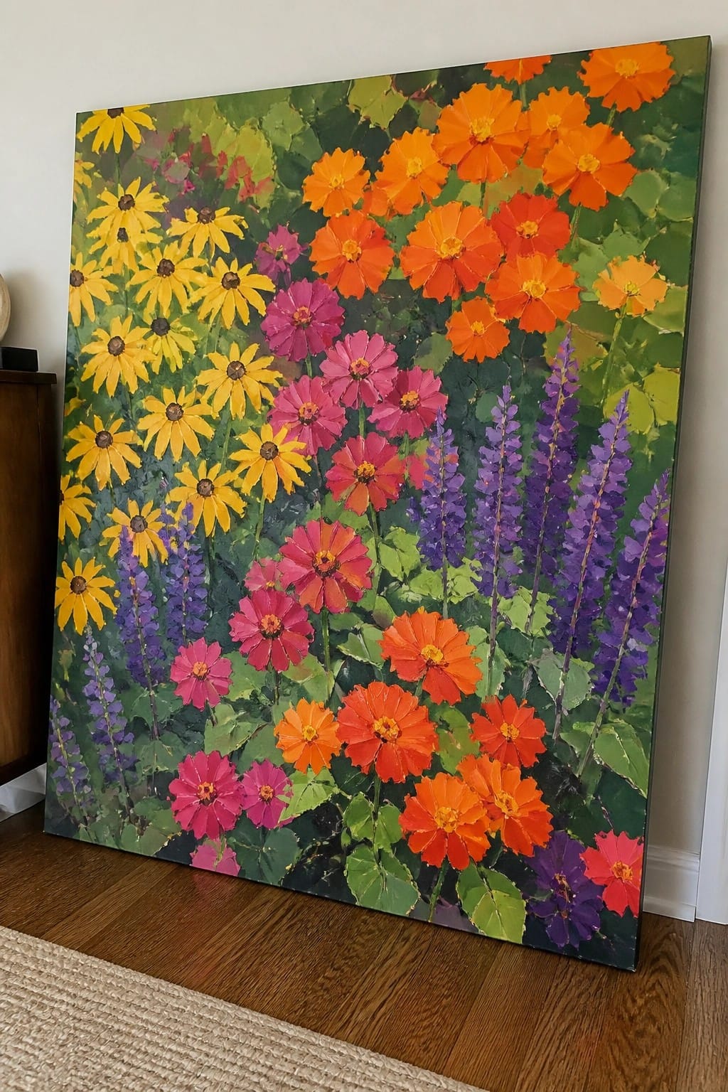 Vibrant painting of colorful flowers in yellow, orange, pink, and purple leaning on floor