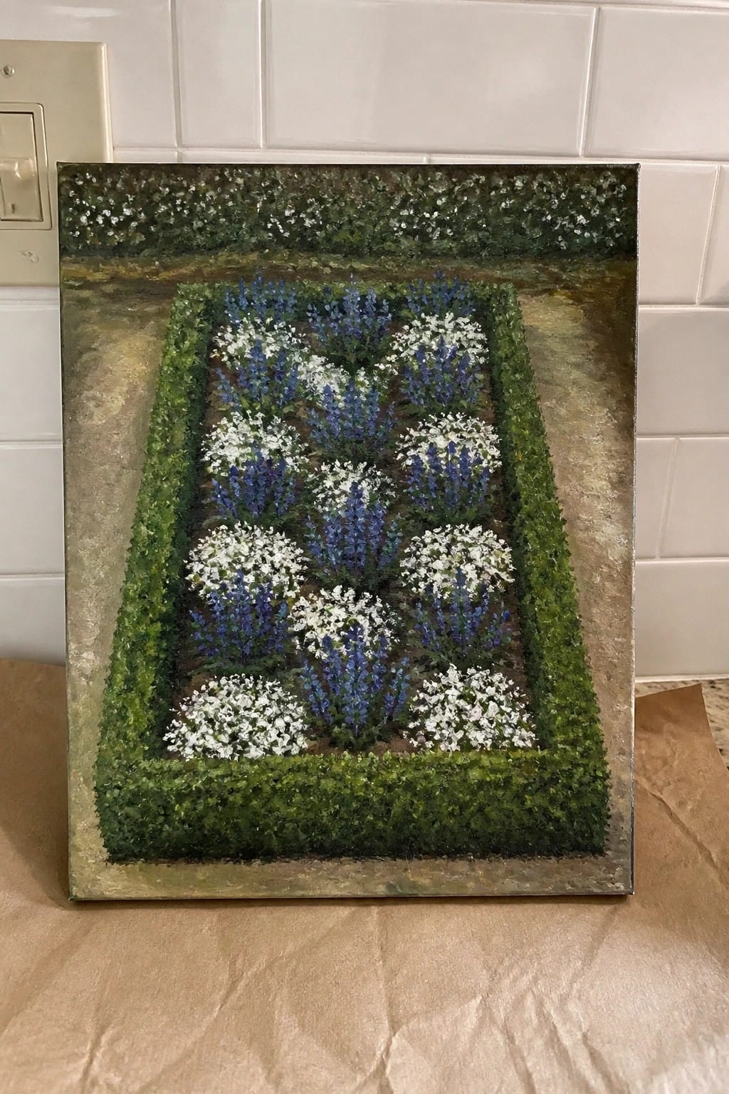Rectangular painting of blue and white flowers in hedge-bordered garden rows against tiled wall