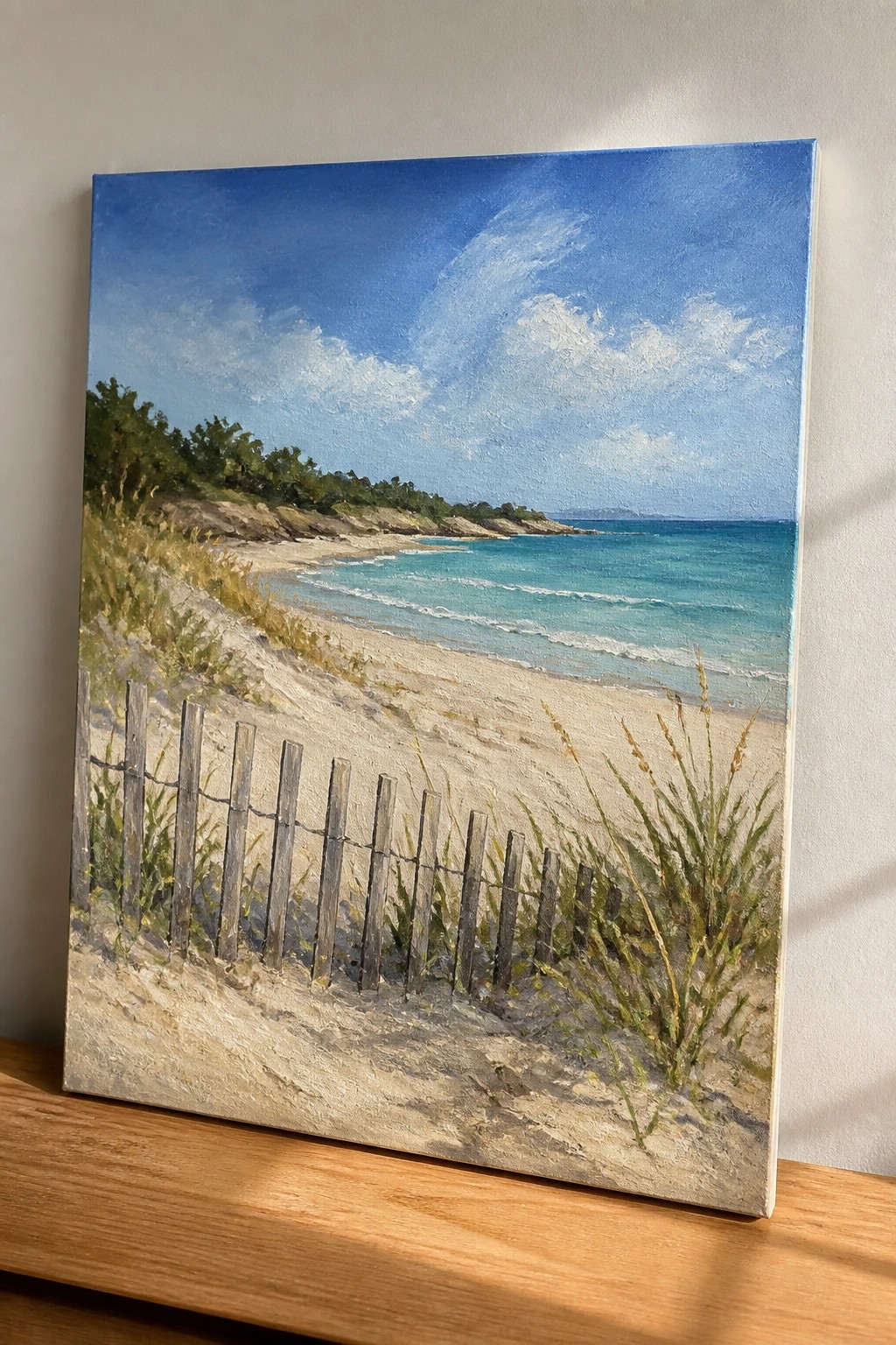 Coastal painting of sandy beach with wooden fence, grassy dunes, turquoise waves, and blue sky.