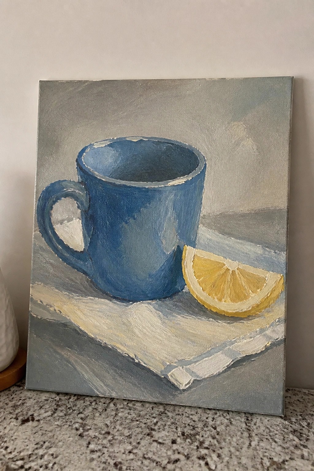 Blue mug with lemon slice on checkered cloth in painted still life