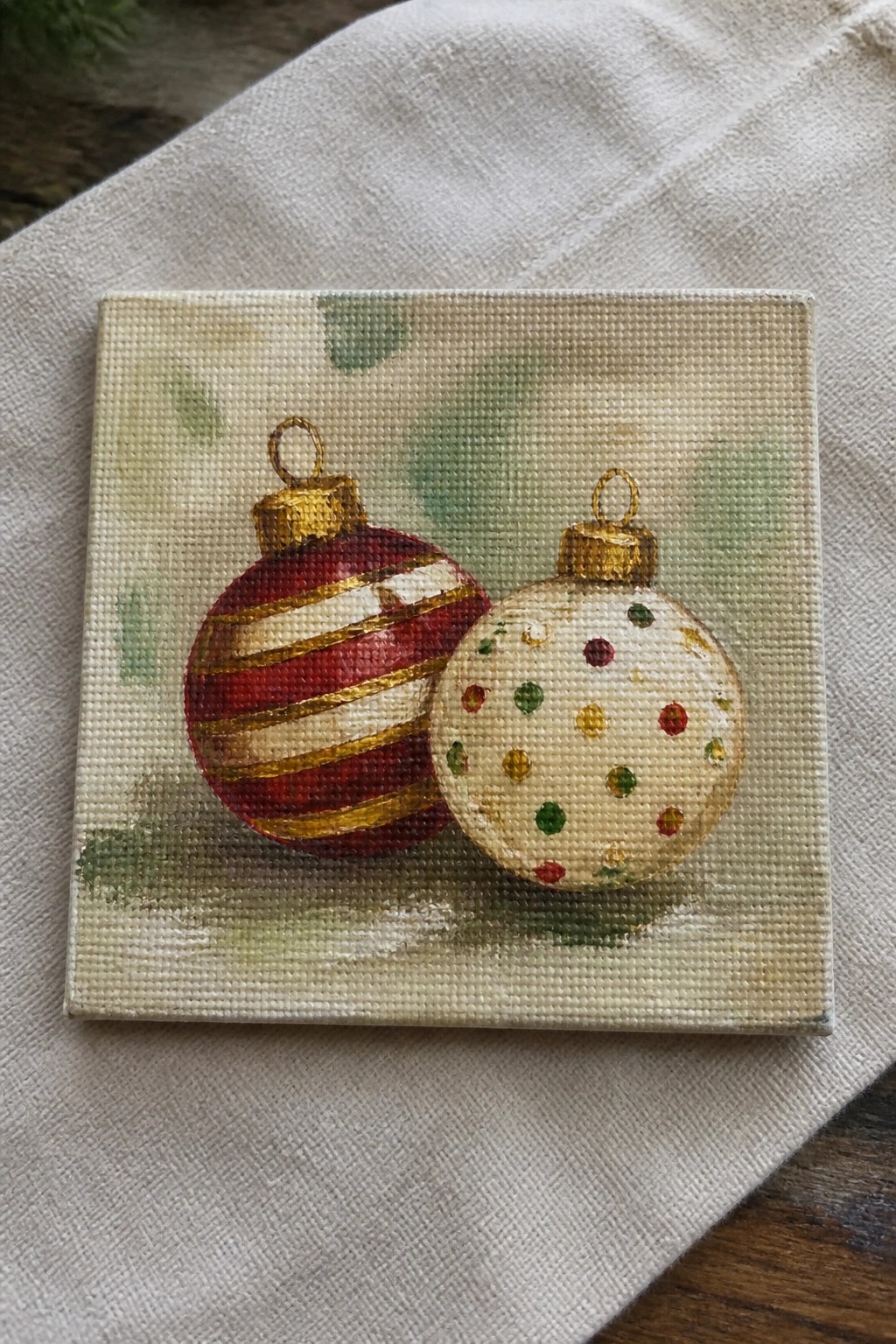 Small square canvas painting of red striped and white polka-dot Christmas ornaments