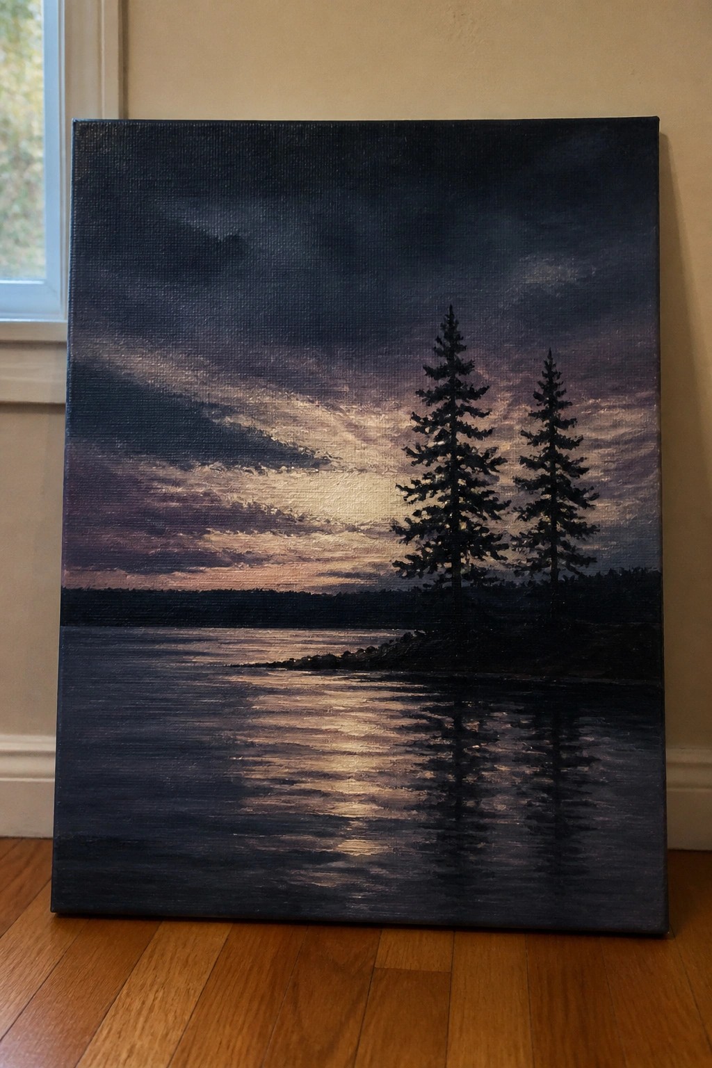 Painting of sunset over lake with two silhouetted pine trees and golden water reflections.