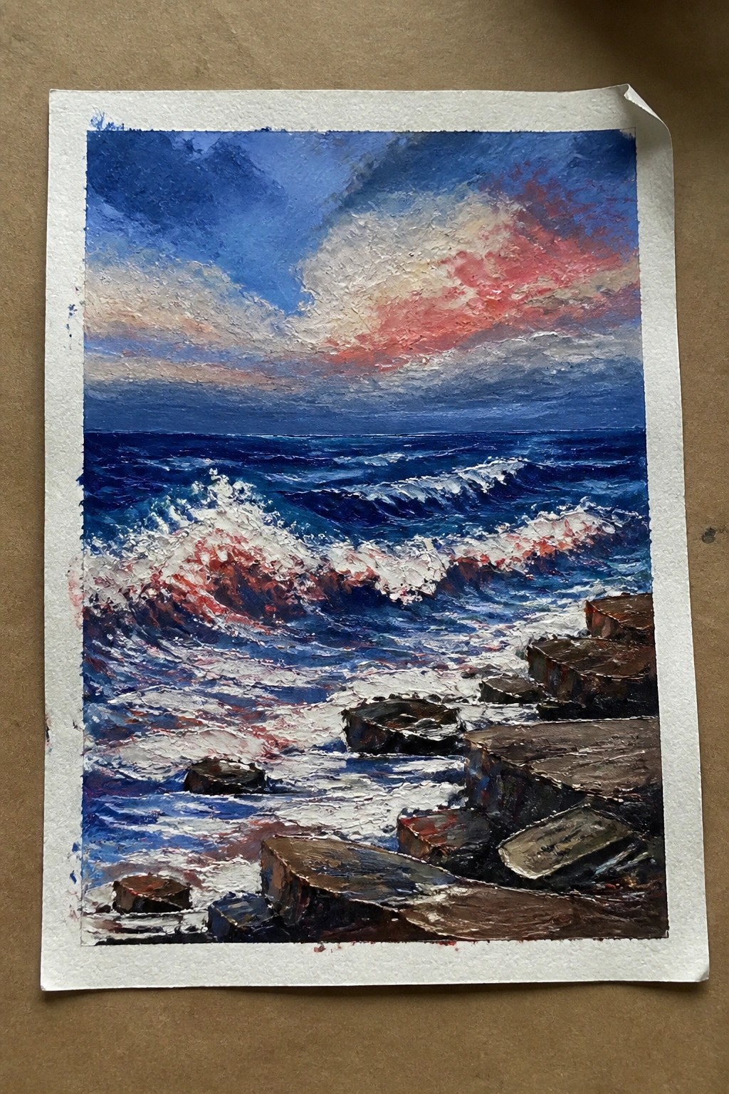 Impasto painting of red-tinged waves crashing on dark rocks under dramatic sunset sky