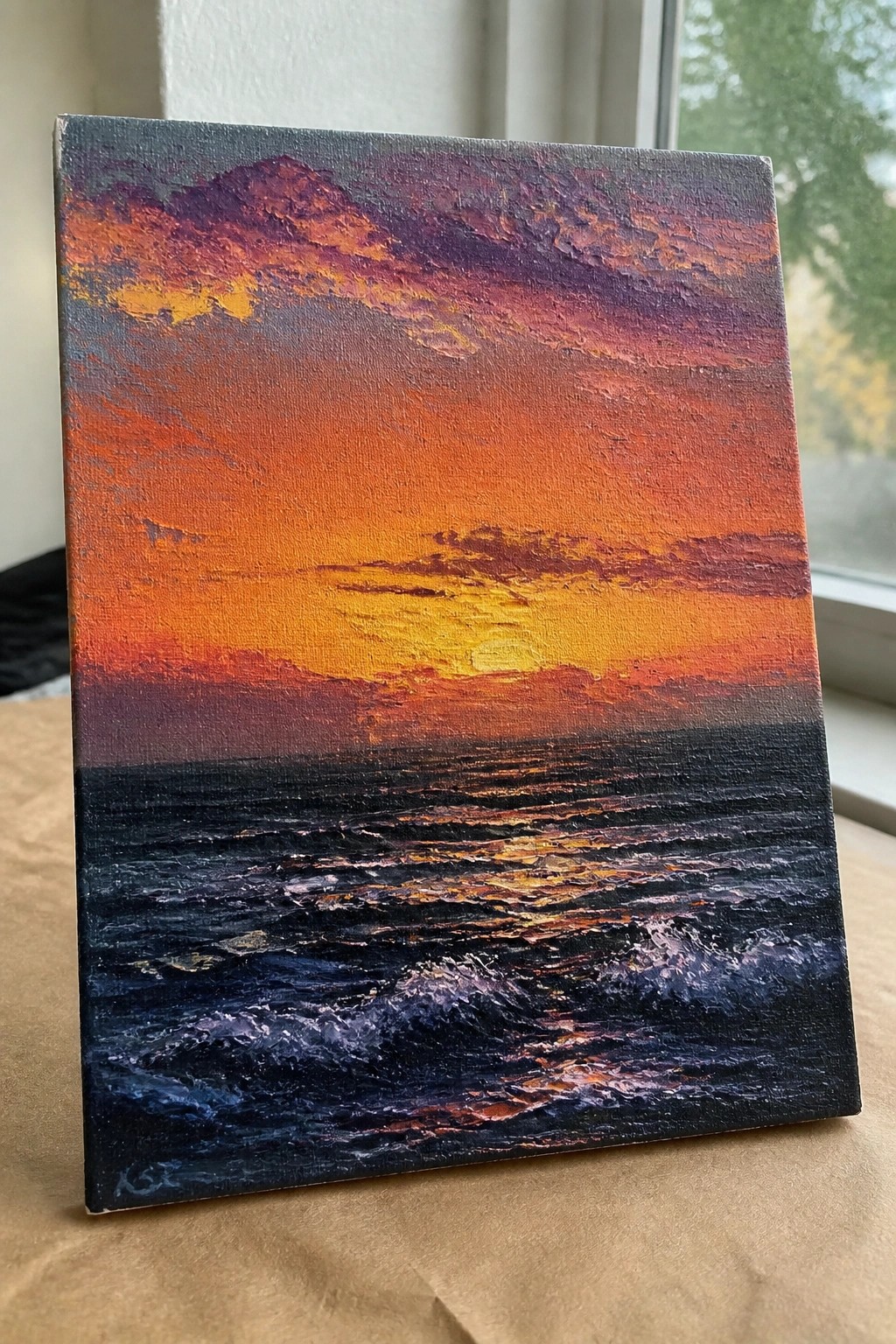 Vibrant sunset painting with orange-purple skies reflecting on dark ocean waves