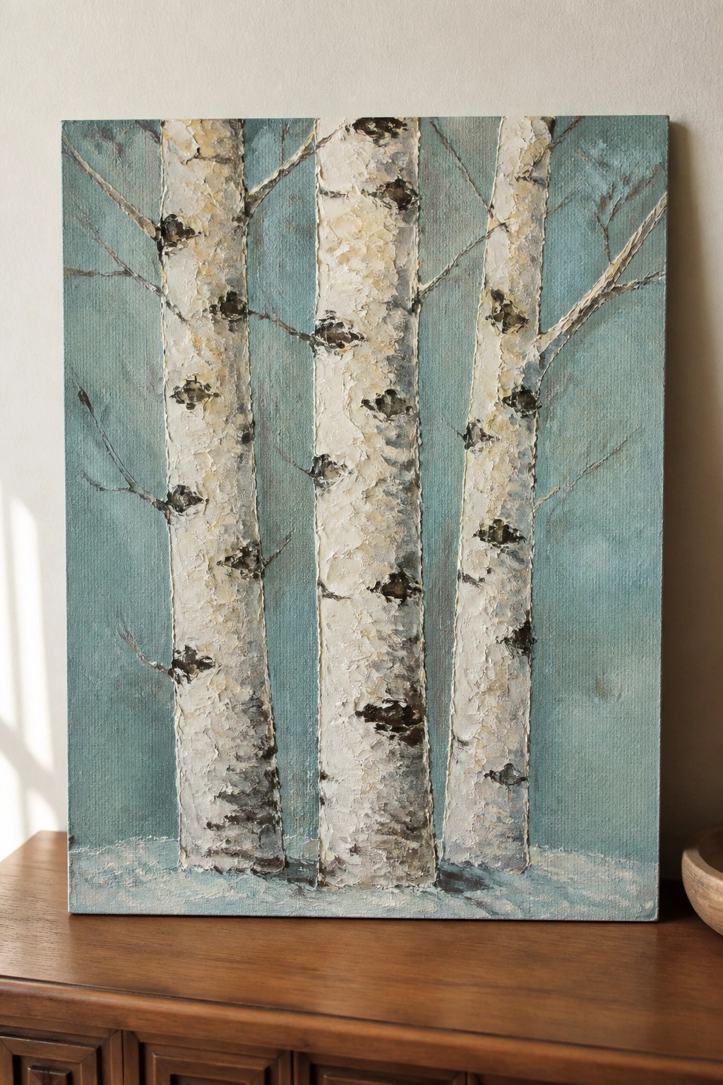 Textured painting of four white birch trunks with branches on teal background.