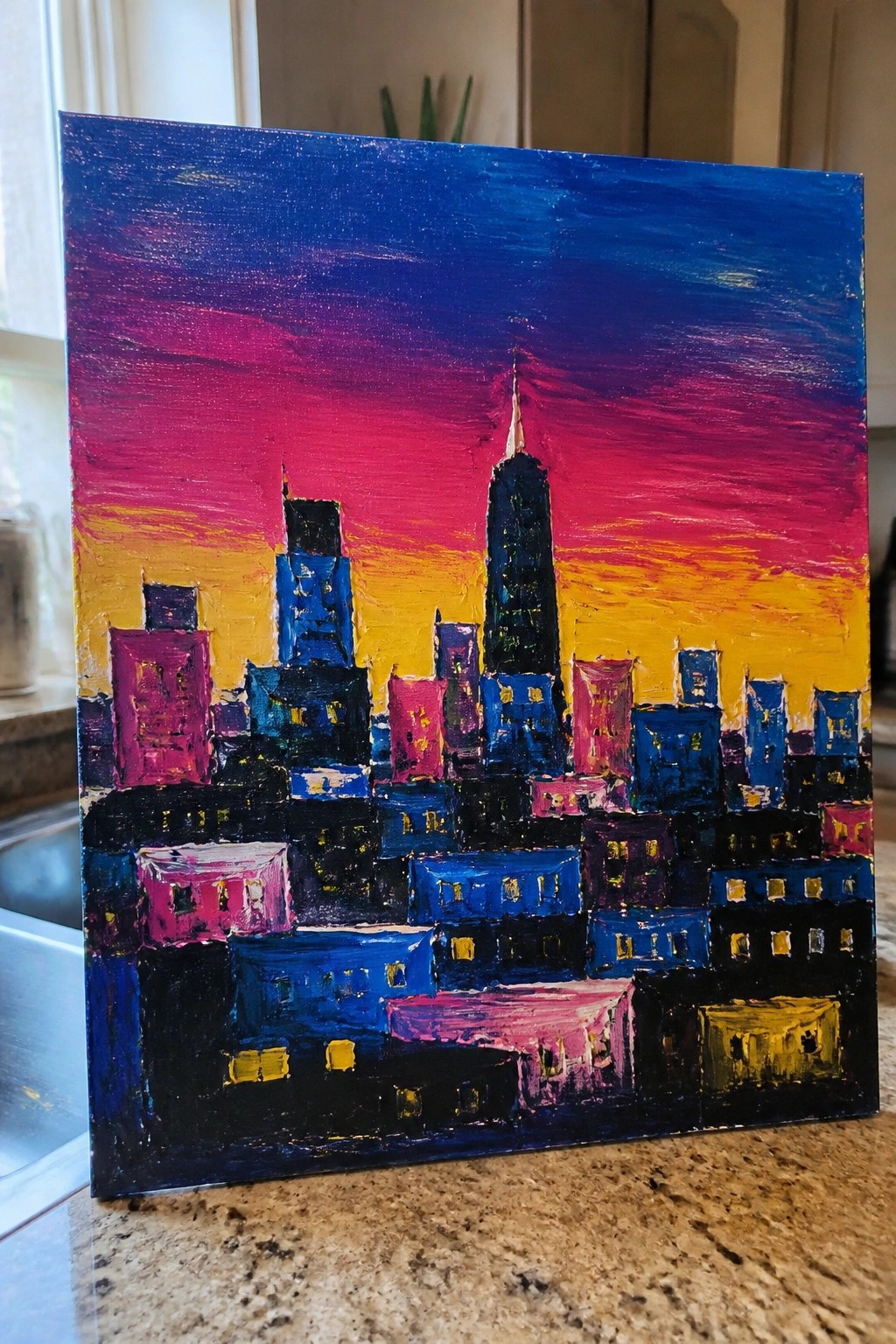Vibrant abstract painting of a colorful city skyline at sunset with glowing windows