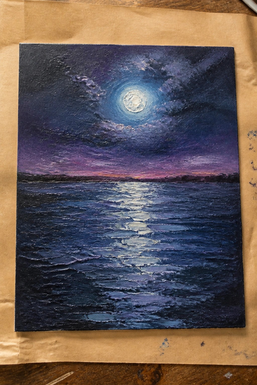 Oil painting of full moon glowing over rippled dark blue sea under purple clouds.