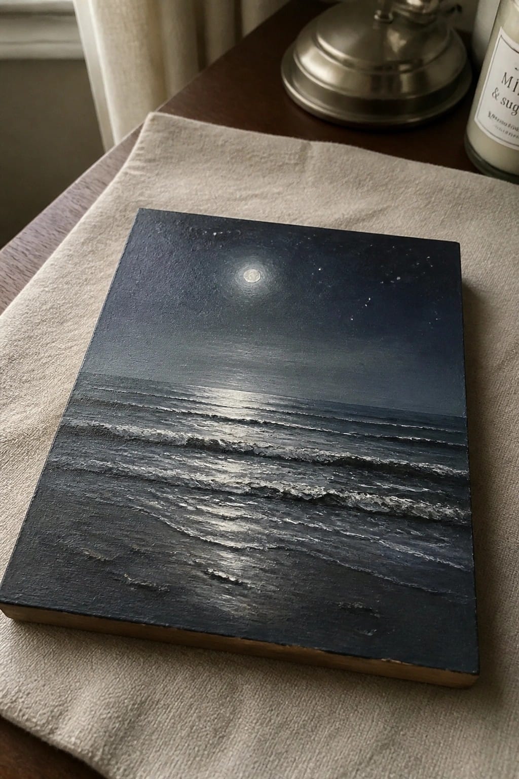 Textured painting of moonlight reflecting on dark ocean waves under a full moon