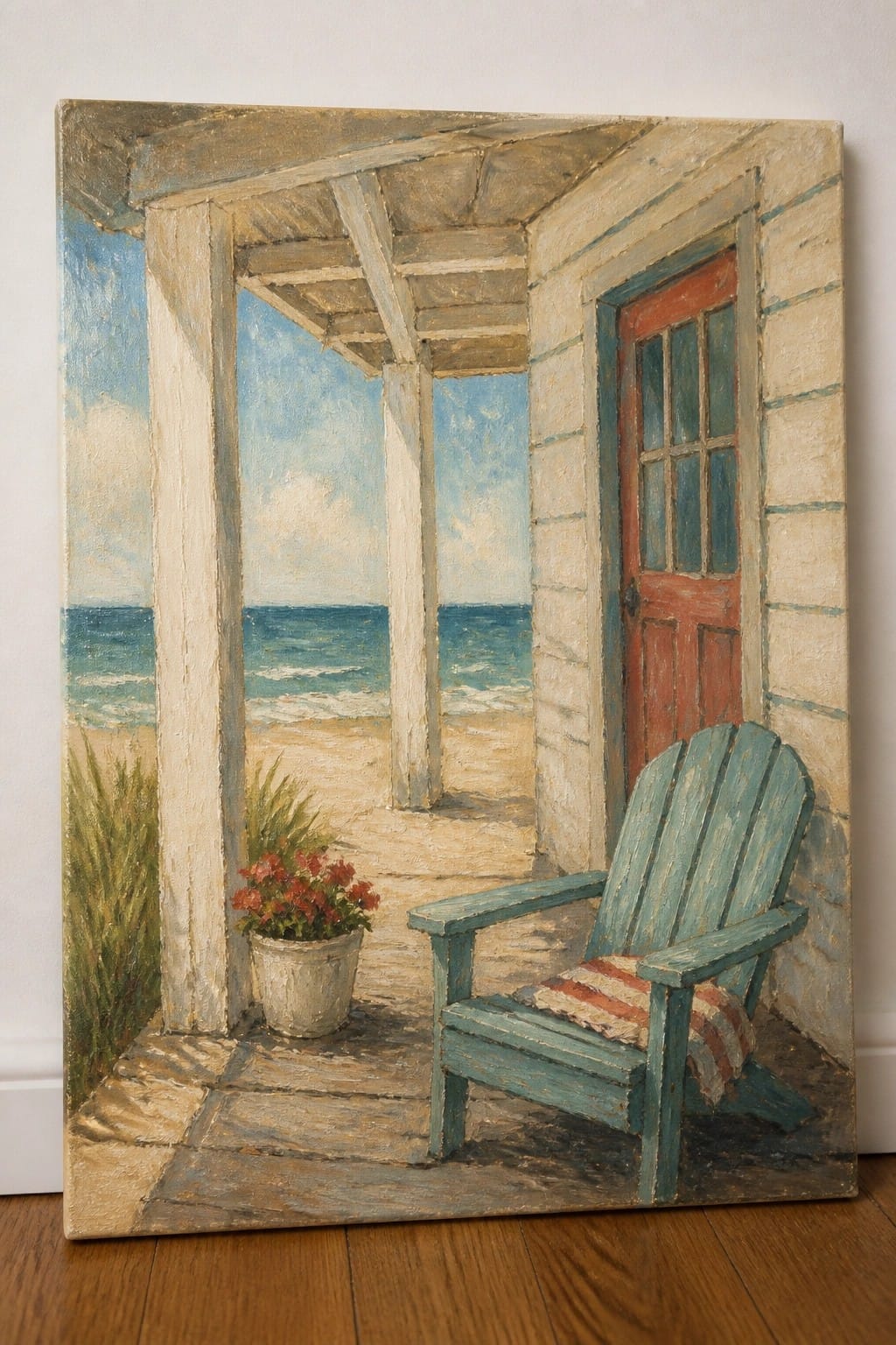 Realistic oil painting of a beach house porch with a teal wooden chair, potted red flowers, red door, and direct view of sand and ocean waves under a blue sky.