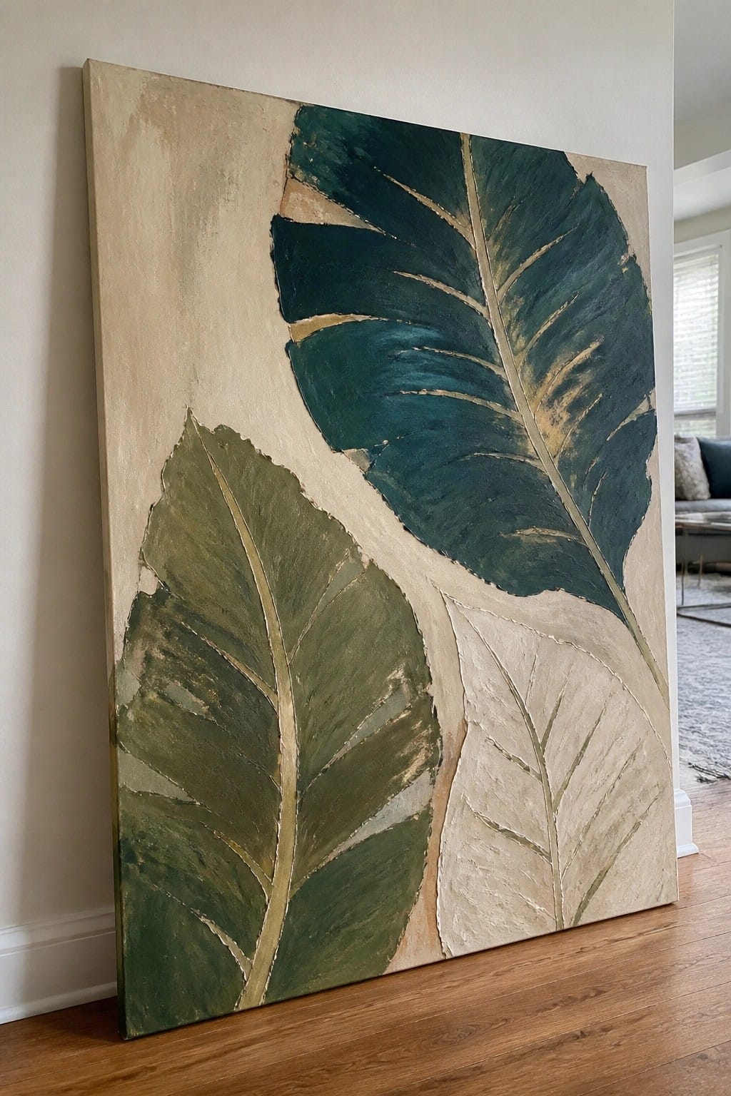 Abstract painting of oversized tropical leaves in green, beige, and gold tones