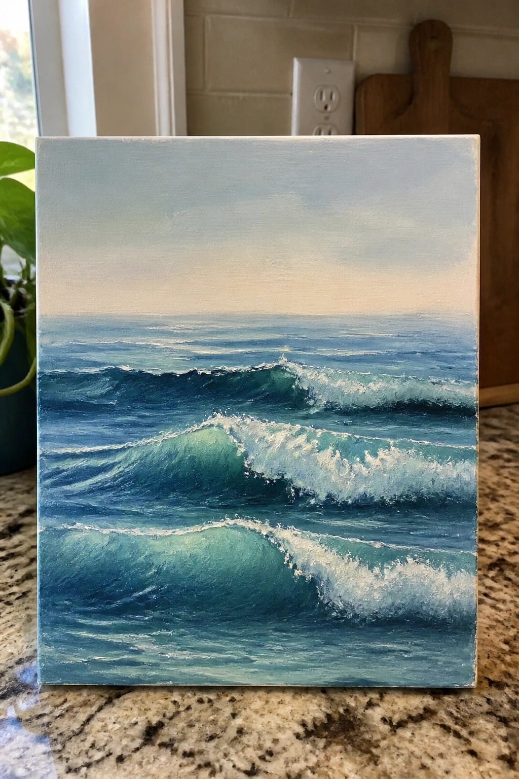 Painting of blue-green ocean waves with white foam on marble countertop