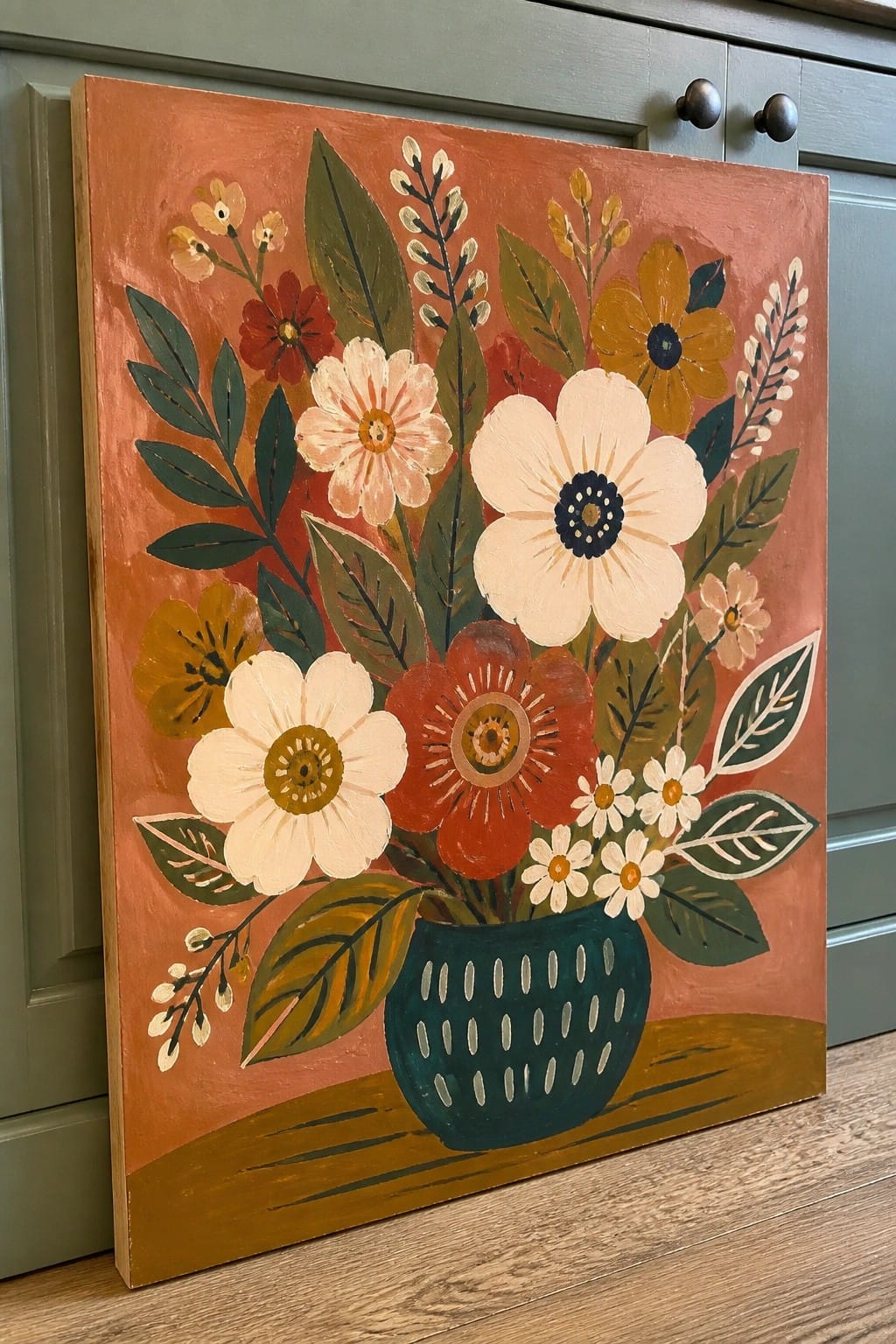 Colorful folk-art painting of flowers in a teal vase against orange background