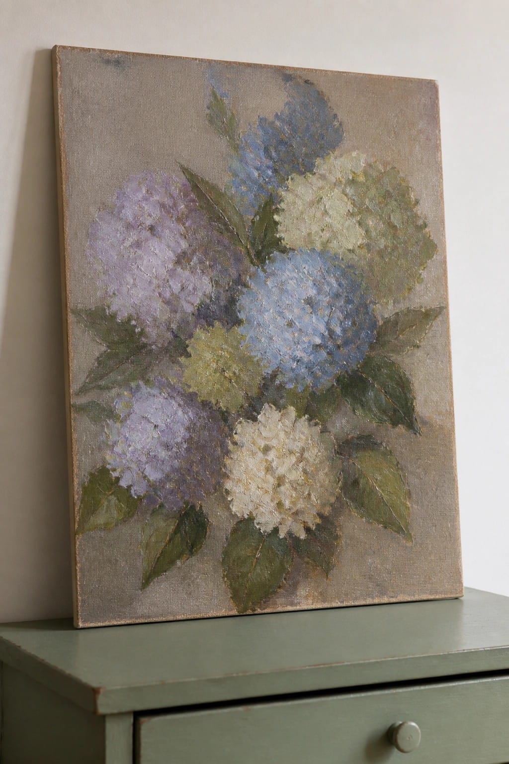 Textured painting of blue, purple, and white hydrangeas on a green dresser.