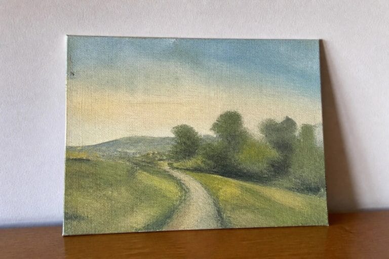 24 Easy Oil Painting Landscape Projects for Beginners on Canvas Winding dirt path through rolling green hills with trees under blue sky.