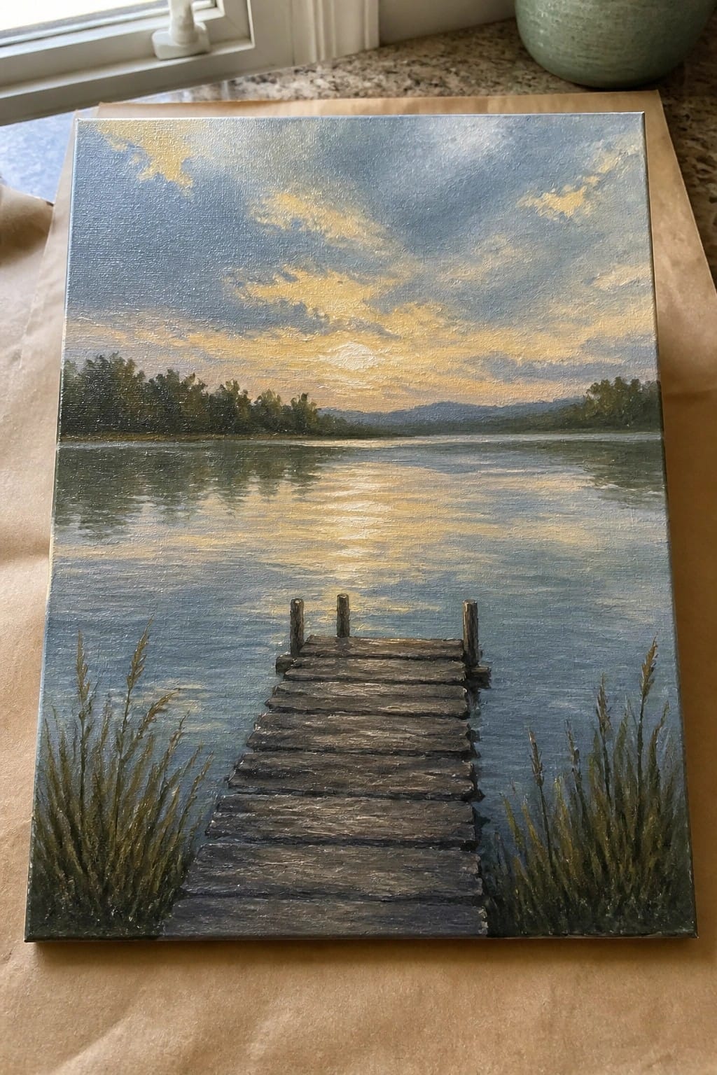 Painting of wooden dock extending into calm lake under golden sunset sky with reflections.