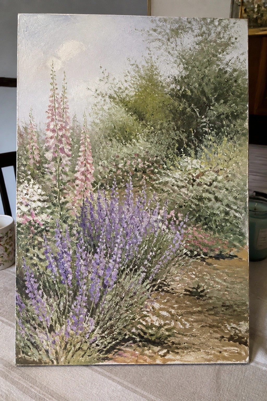 Impressionistic painting of pink foxgloves and purple flowers along a garden path.