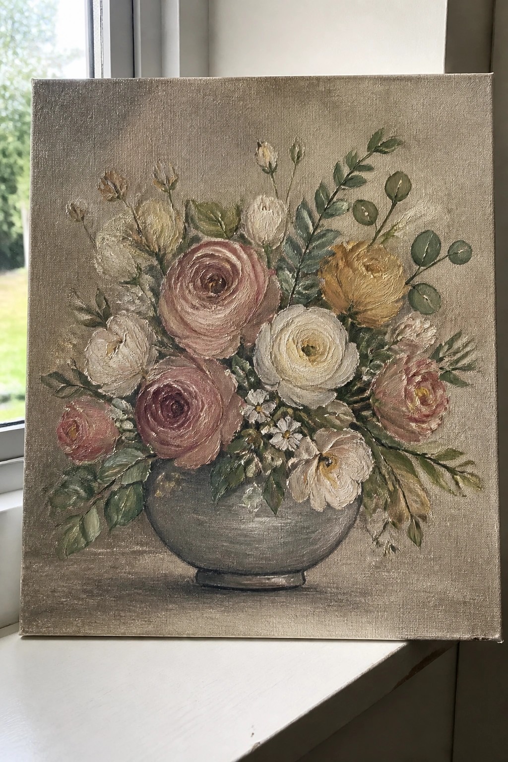 Painting of pink and white roses with greenery in a gray vase on canvas