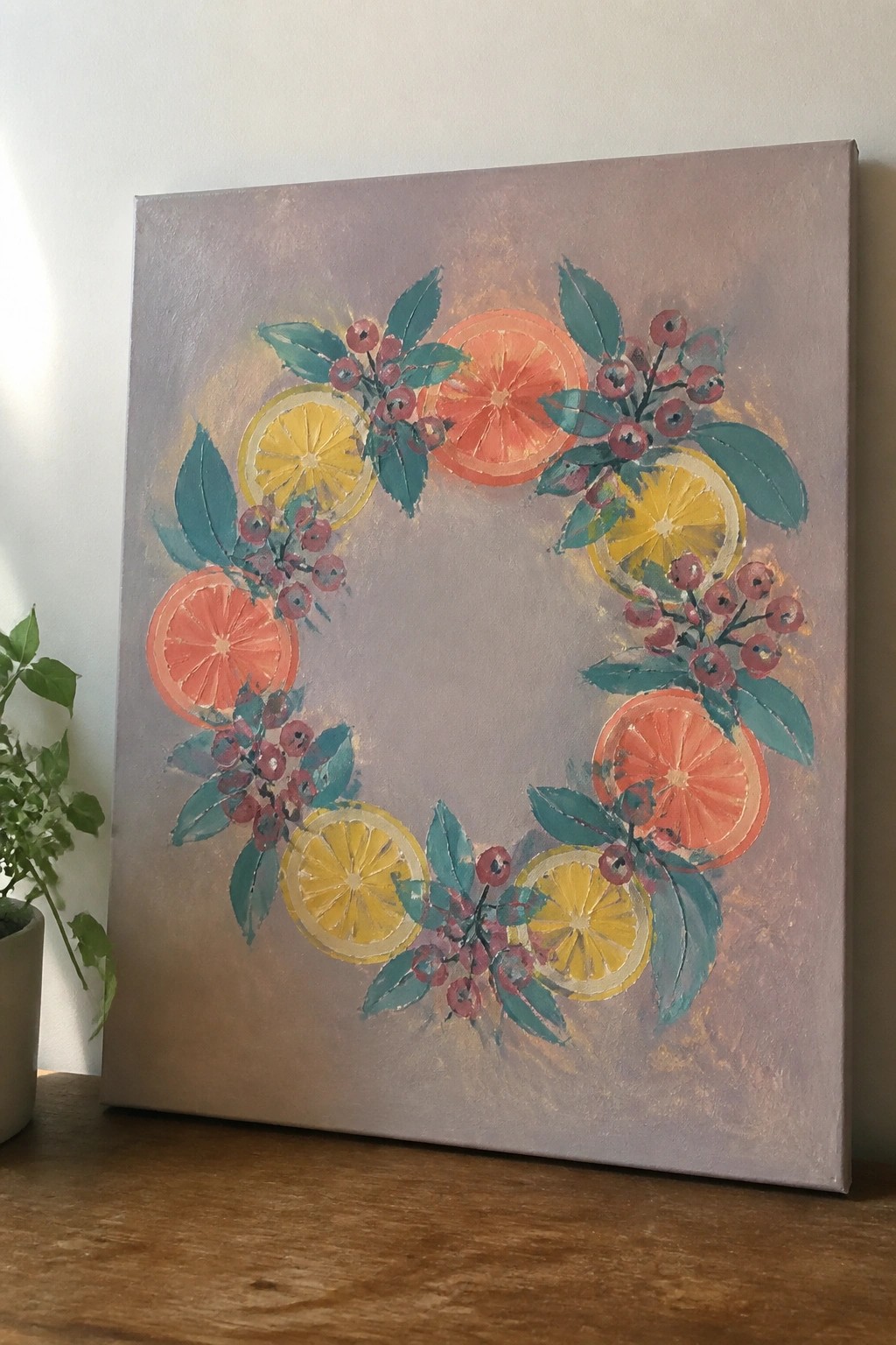 Vibrant wreath of citrus slices, berries and leaves on purple canvas