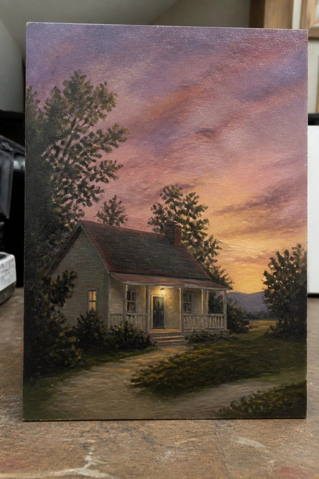 Rustic house with glowing porch light on a path under purple-orange sunset sky.