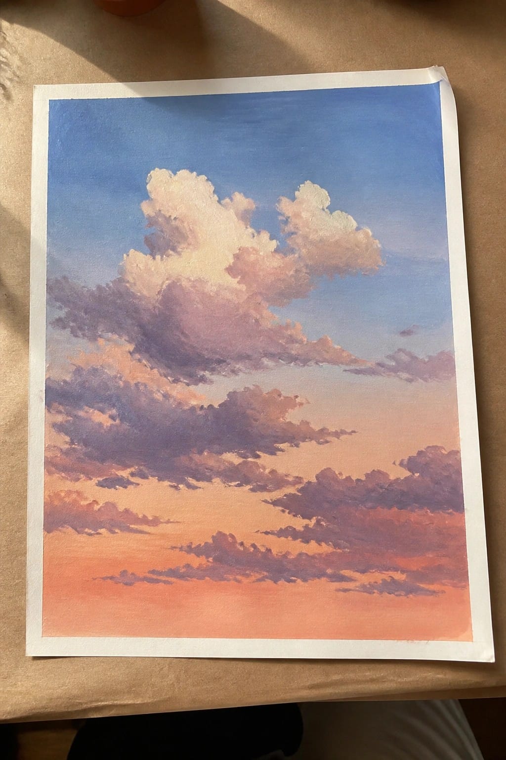 Impressionistic painting of fluffy clouds in blue pink and orange sunset sky