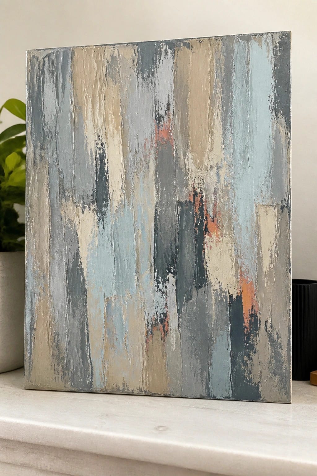 Abstract painting with vertical gray, blue, beige brushstrokes and orange accents on canvas