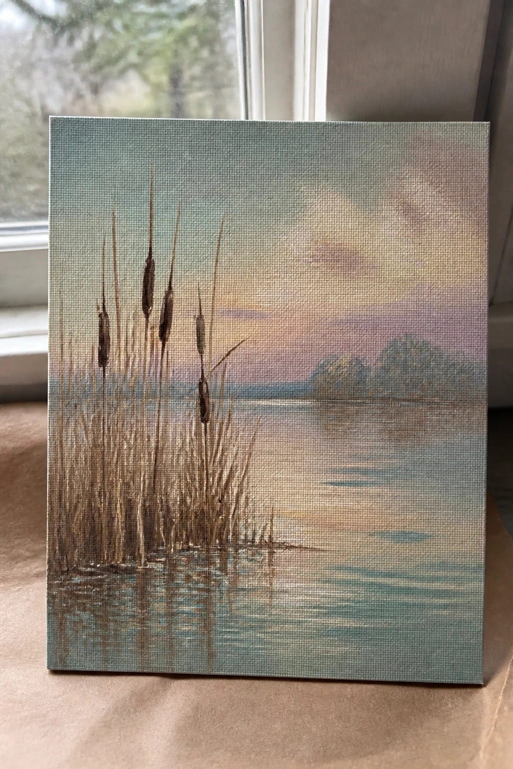 Painting of reeds in water at sunset with pink-purple sky.