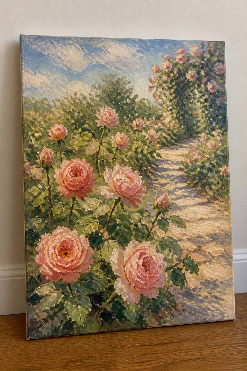 Pink roses blooming along a winding garden path under a bright blue sky