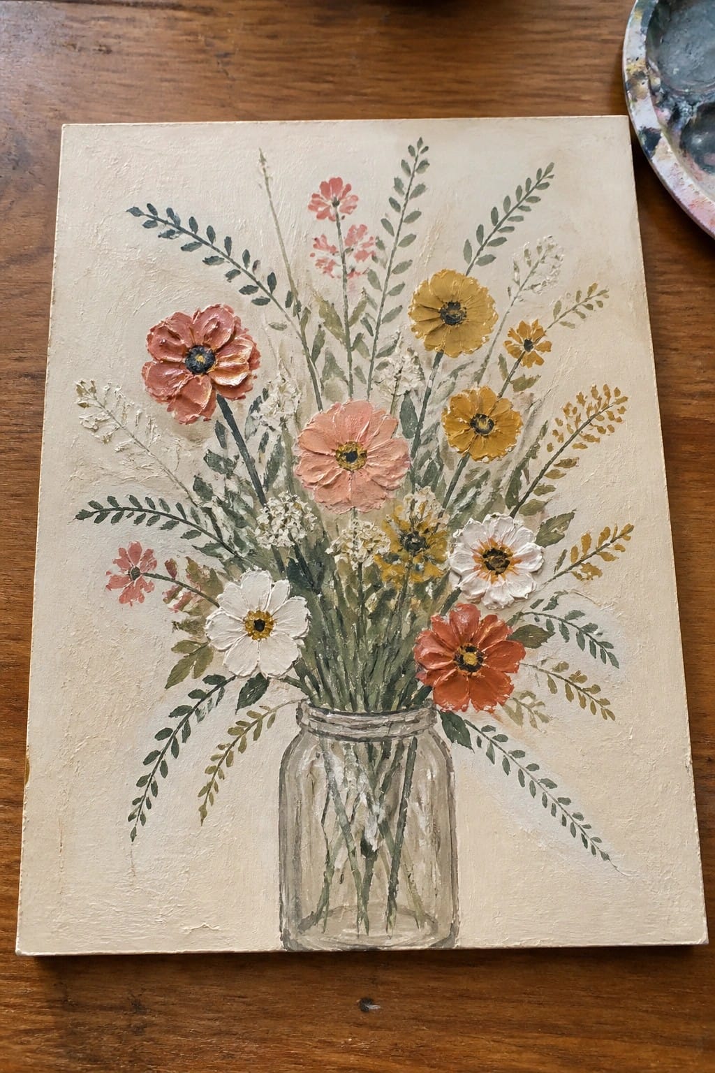 Textured painting of pink, yellow, white, and red flowers in a glass mason jar