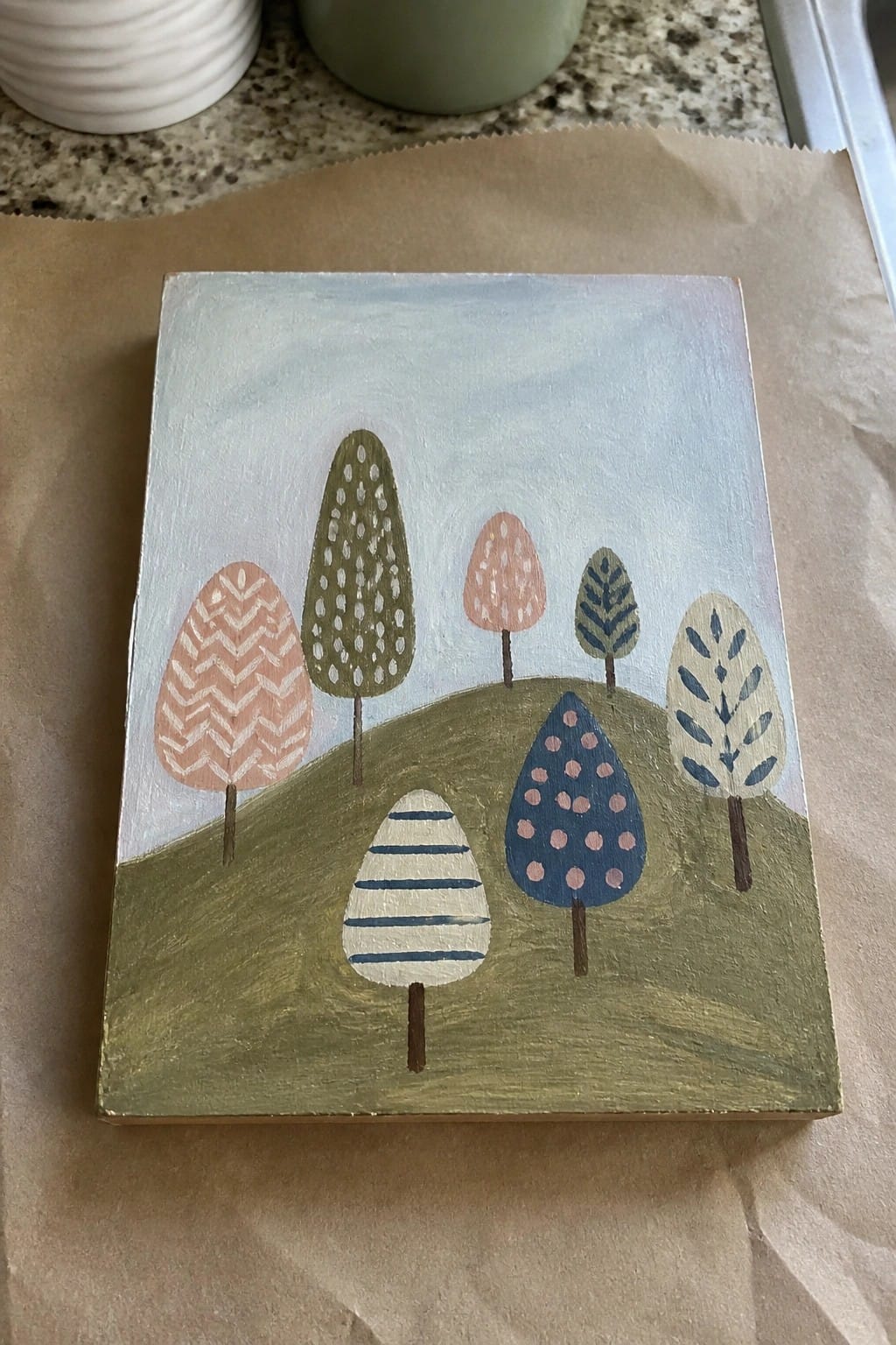 Pastel patterned trees on rolling green hills, small acrylic landscape painting