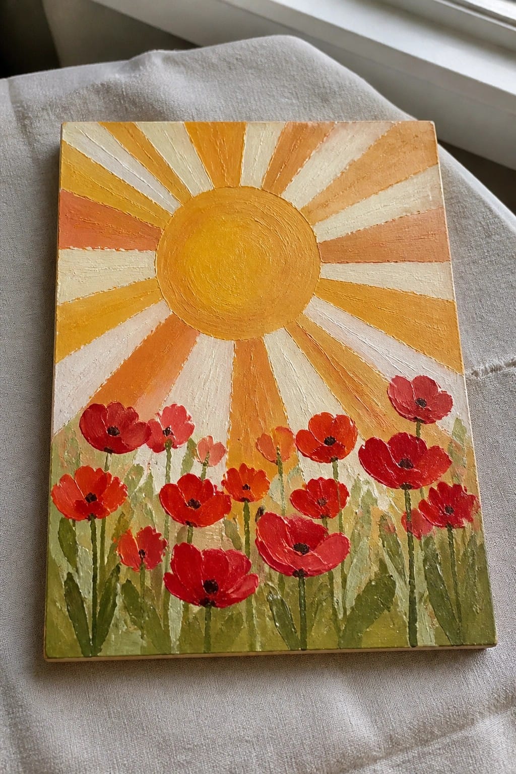 Painting of yellow sun with rays above red poppies on green field.