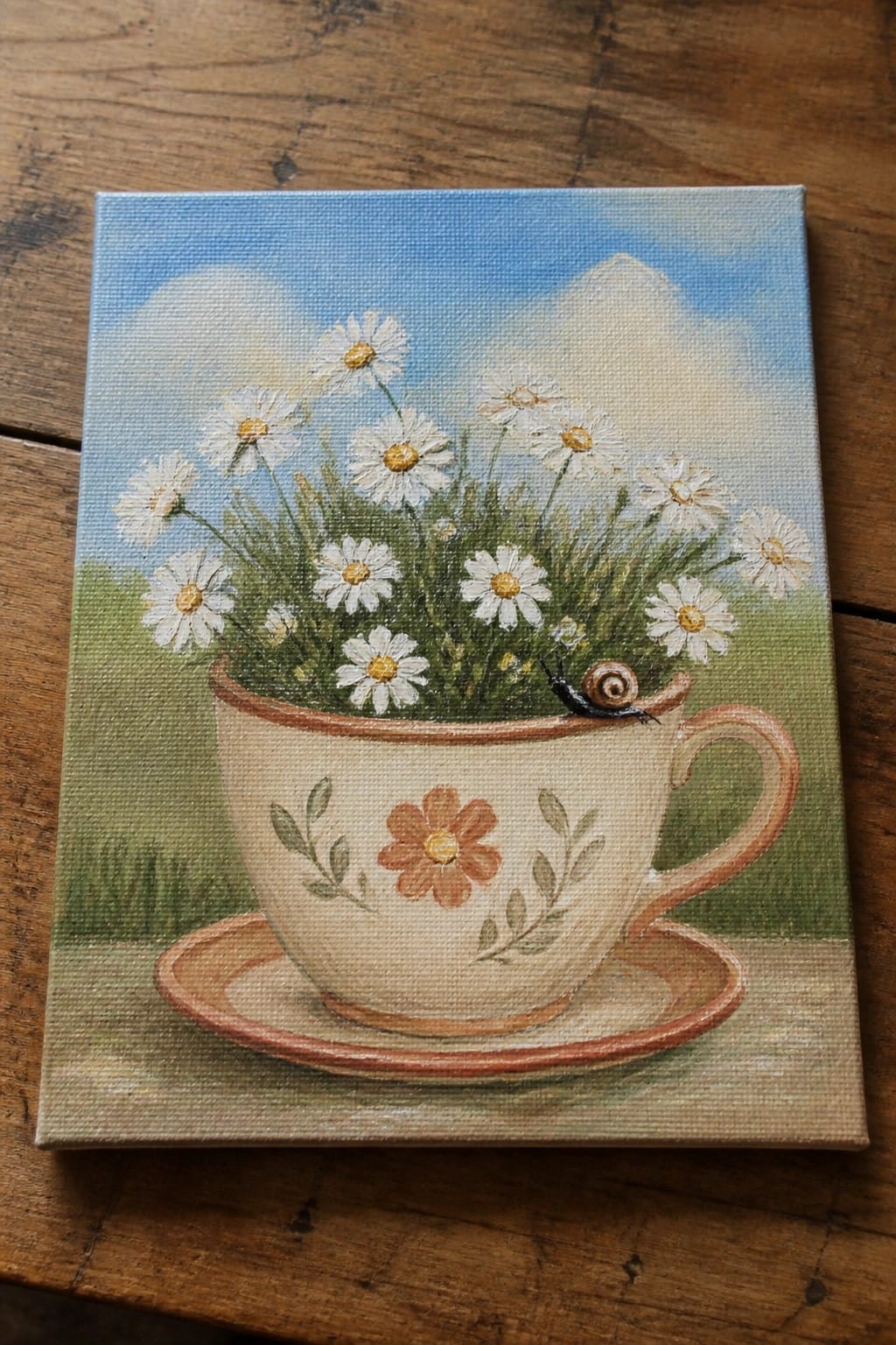 Teacup brimming with daisies and grass, snail on rim against blue sky.