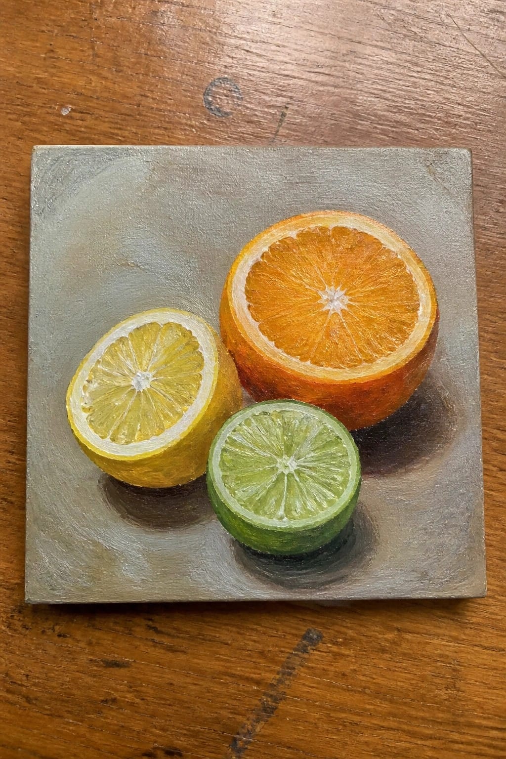 Realistic painting of halved lemon, orange, and lime on gray square surface