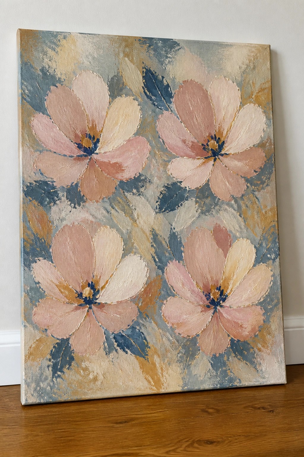 Abstract painting of four pink flowers with blue centers on canvas against wall