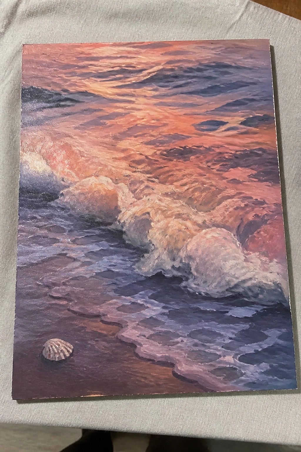 Vibrant oil painting of crashing sunset waves with seashell on wet shore.