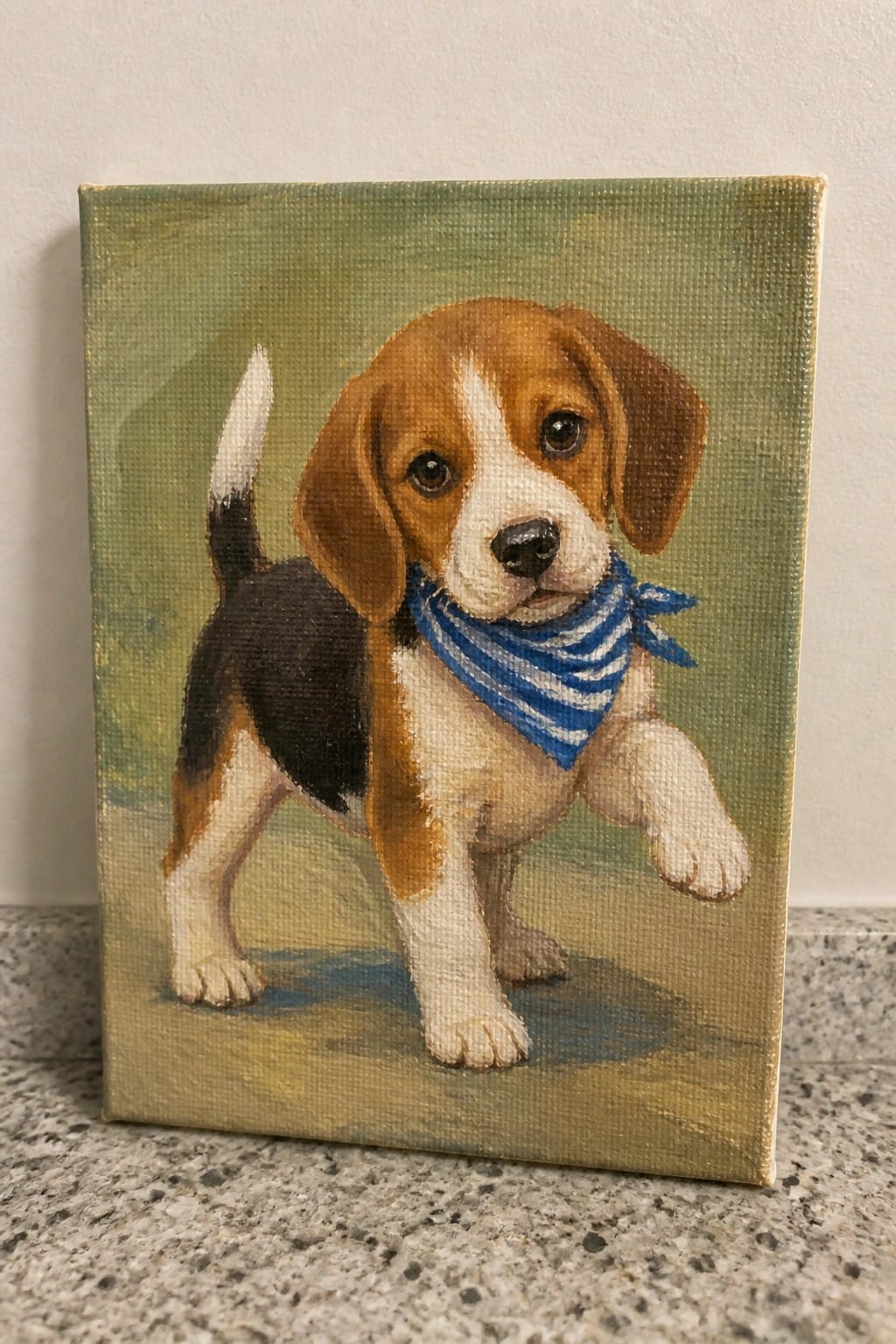 Painted beagle puppy wearing blue striped bandana on green canvas background