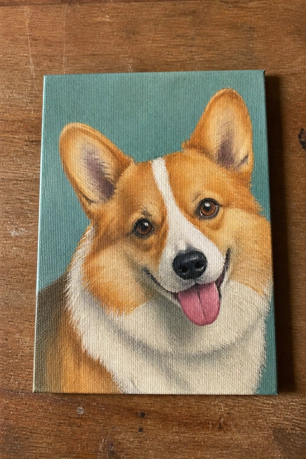 Realistic painting of a corgi with white and tan fur smiling on teal canvas