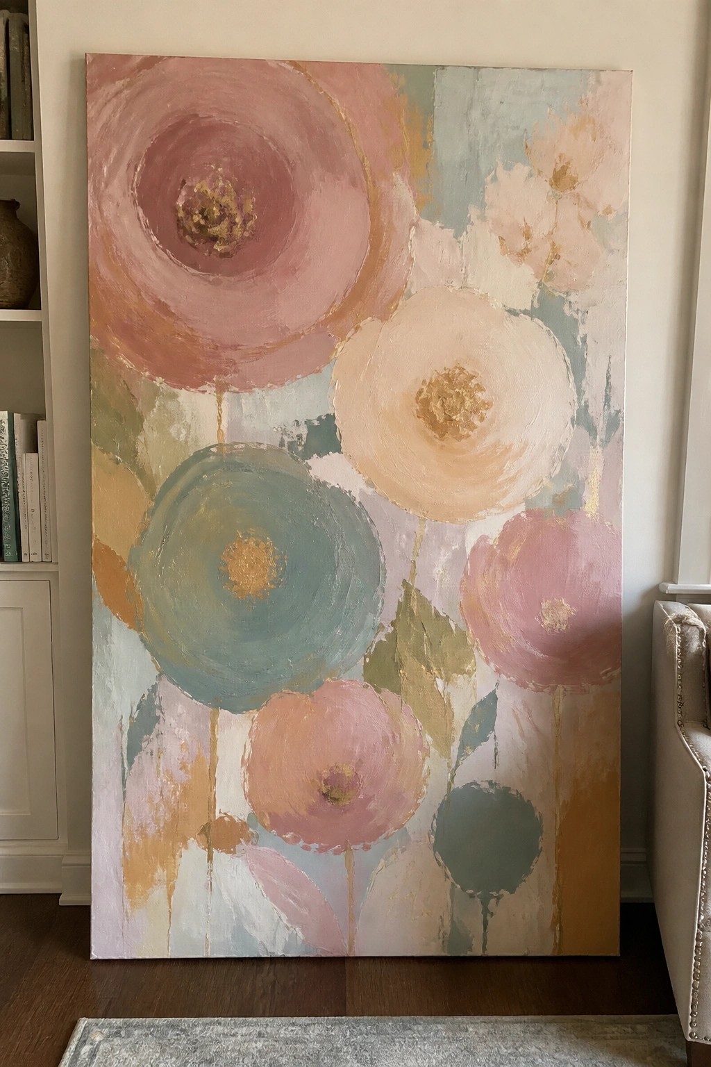 Large oil painting of abstract flowers made from overlapping circles in pink, teal, beige, and gold on a canvas.