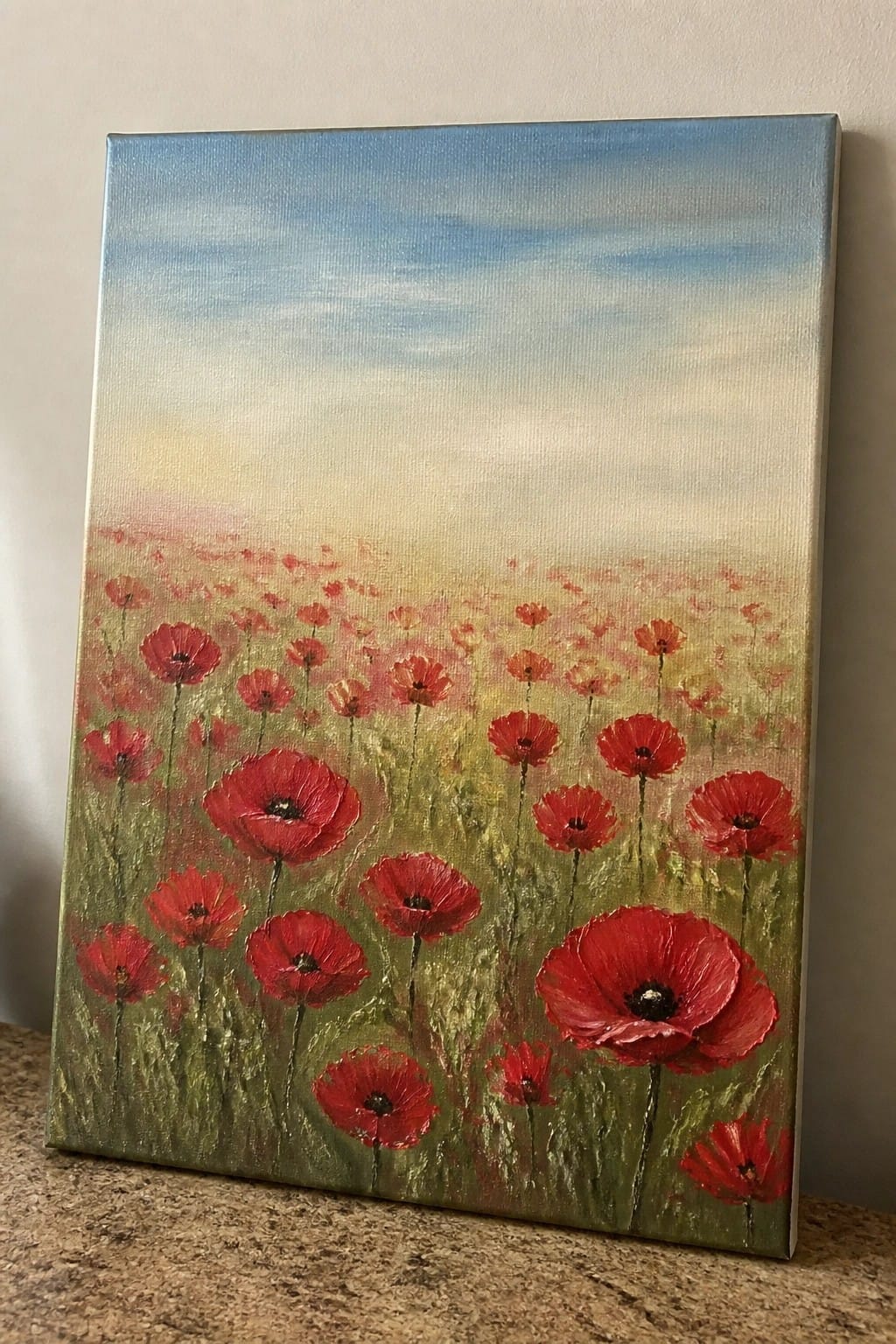 Red poppies blooming in a green field under a soft blue sky painting.