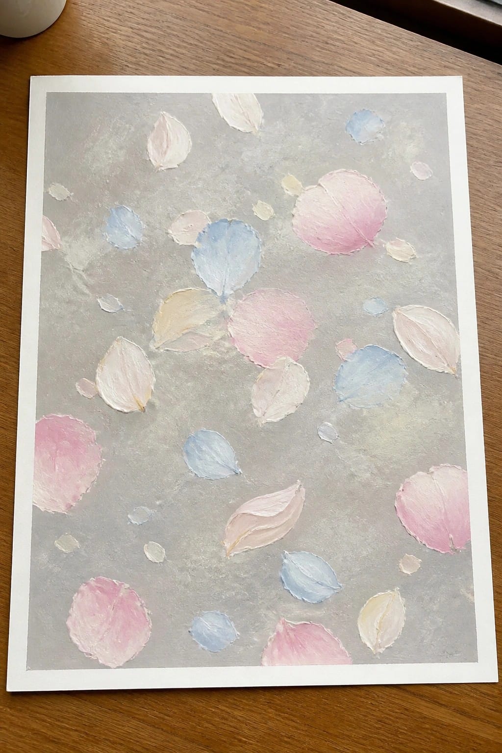 Abstract painting with scattered pastel pink, blue, white, and yellow petals on gray.