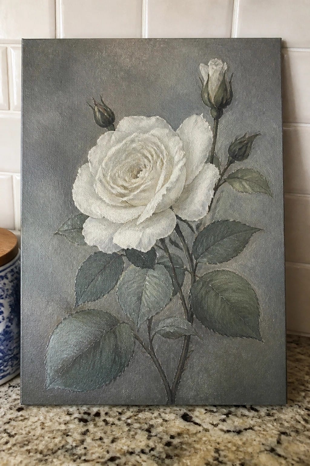 White rose painting with green leaves and buds on gray background.